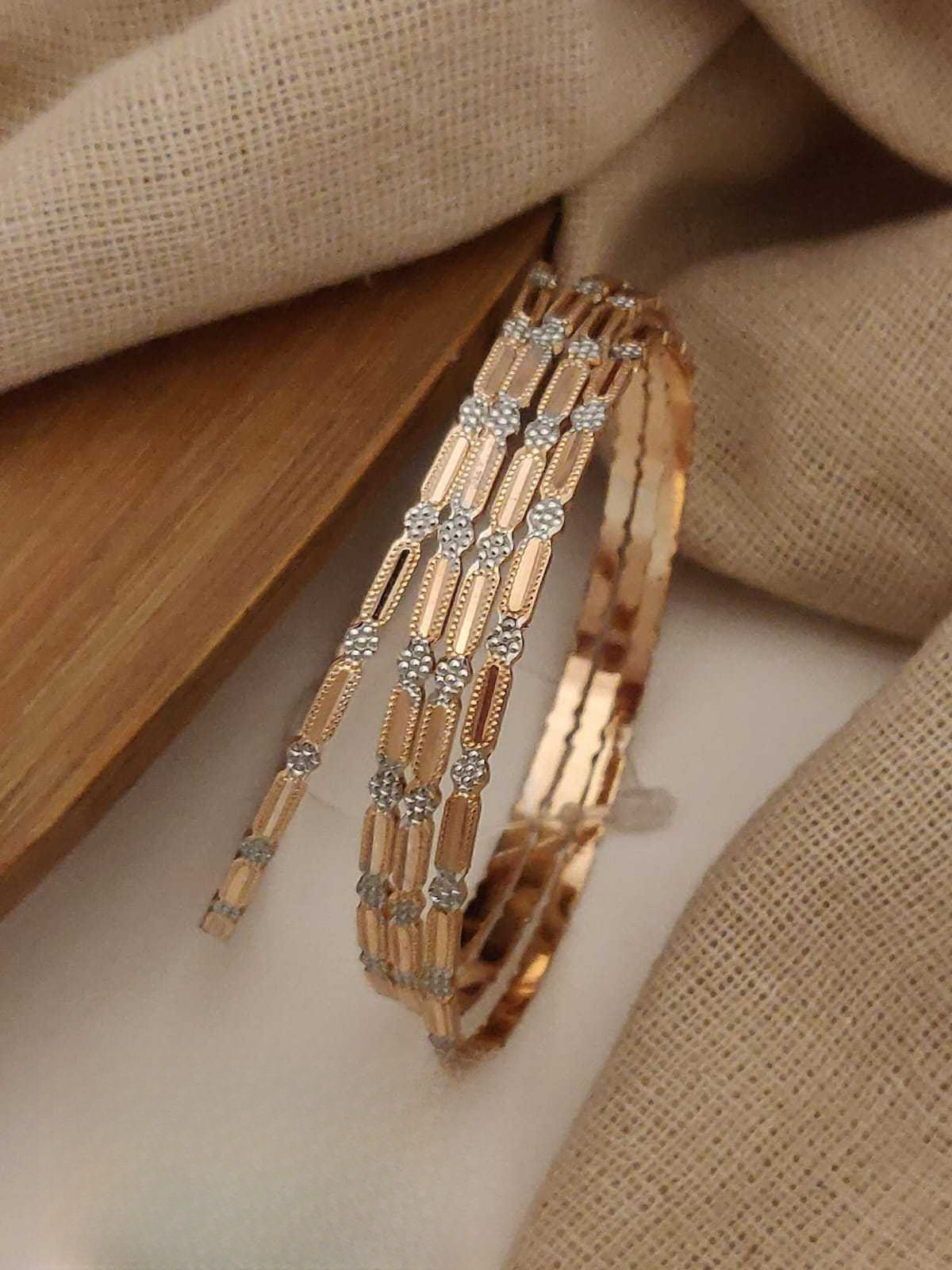 Gold bracelet with diamond accents on a beige fabric background