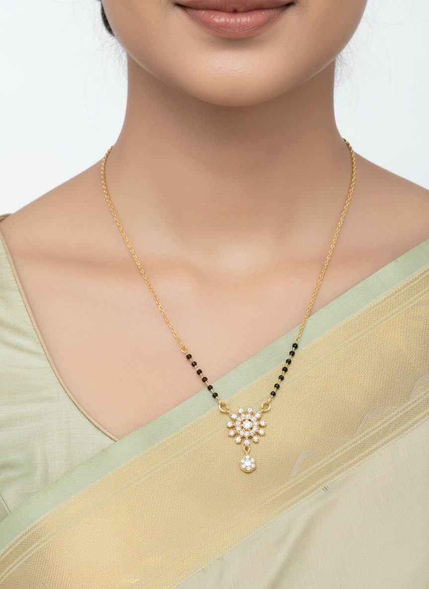 Gold necklace with a pendant on a model wearing a light green saree.