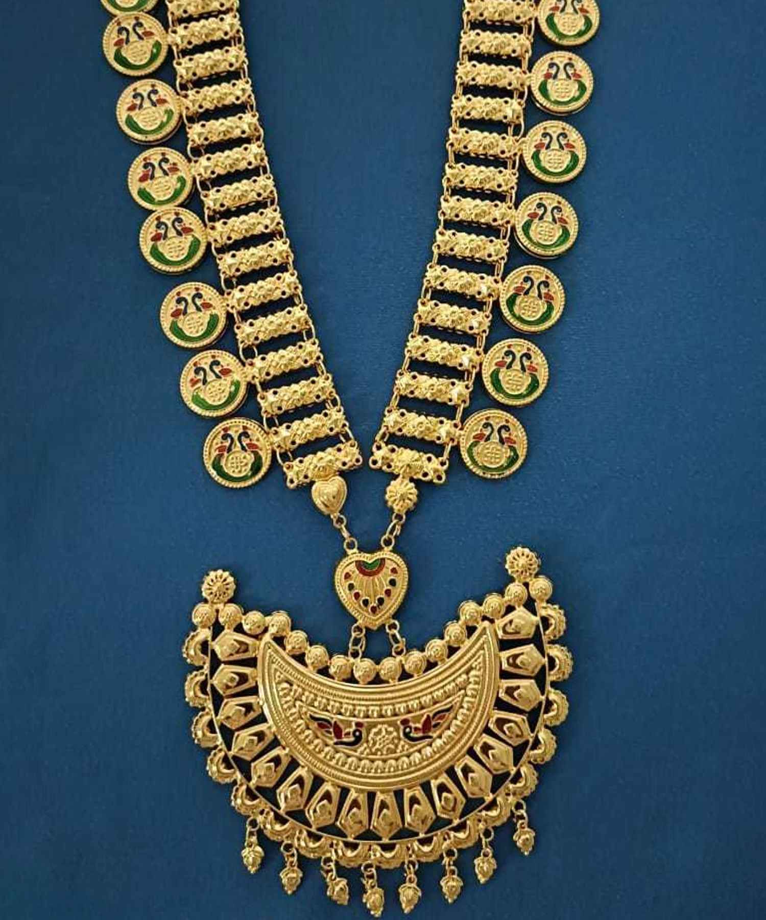 Gold necklace with intricate design on a blue background
