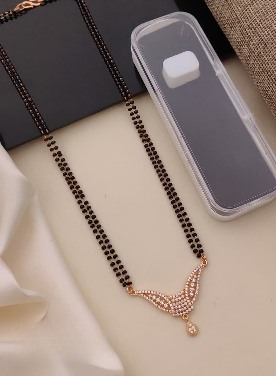 Black beaded necklace with a decorative clasp on a light surface