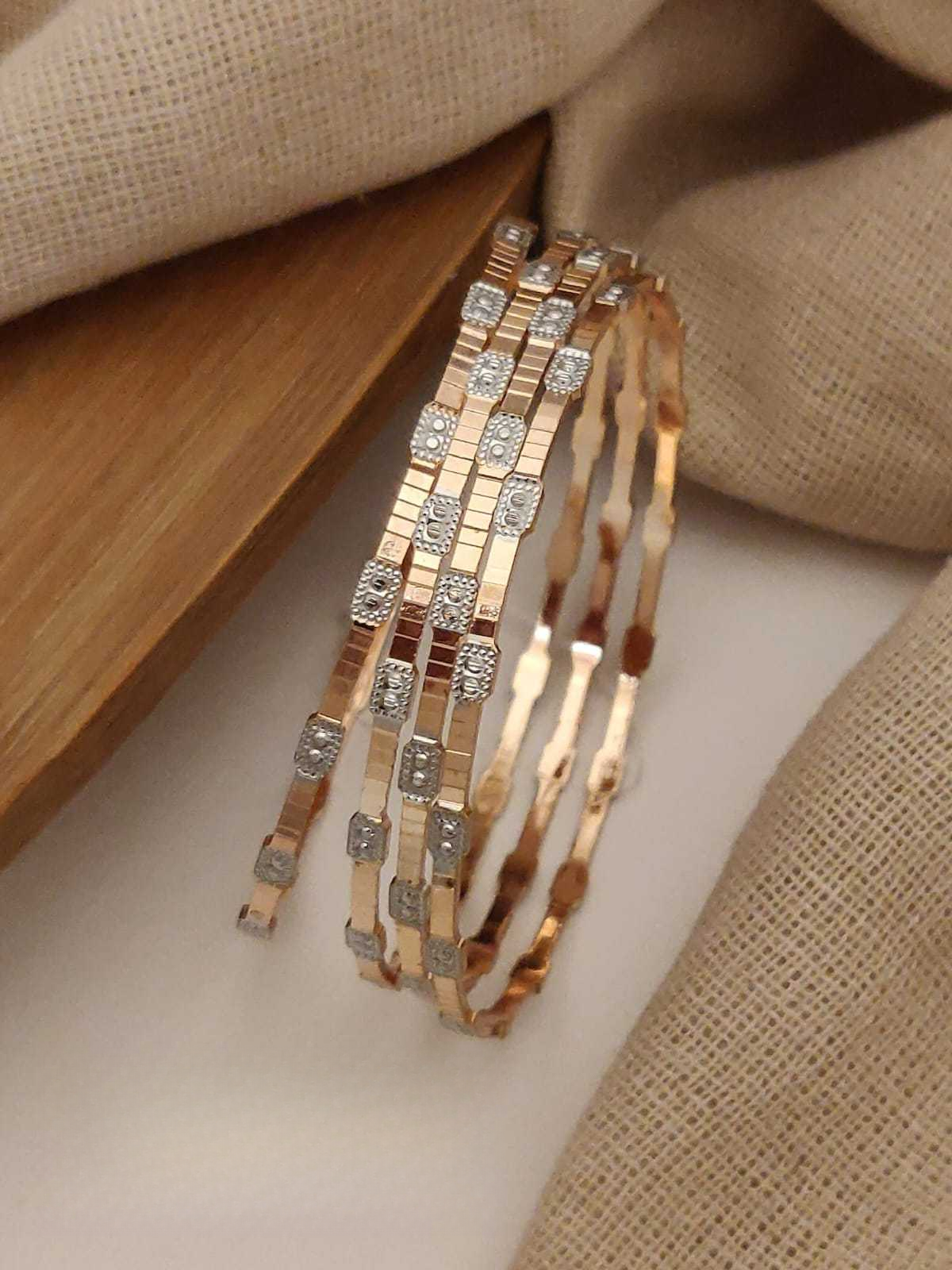 Rose gold bracelet with diamond accents on a neutral background