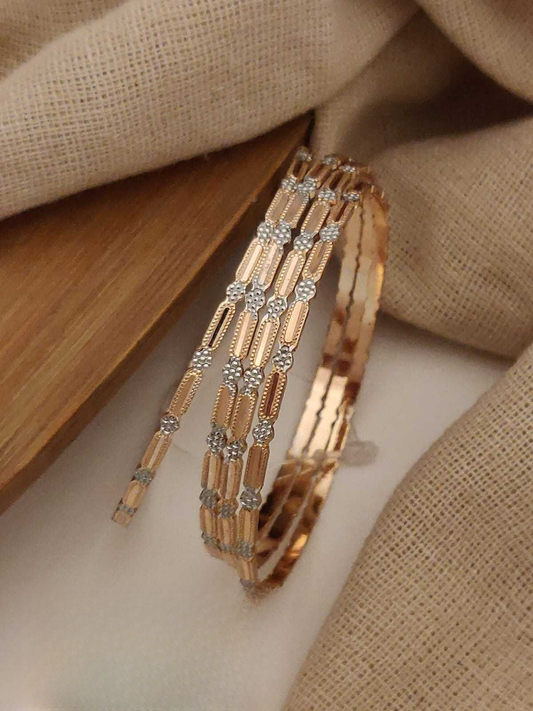 Gold bracelet with diamond accents on a beige fabric background