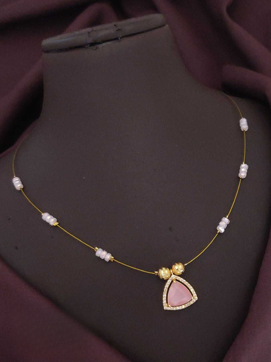 Necklace with a pink pendant on a dark mannequin bust